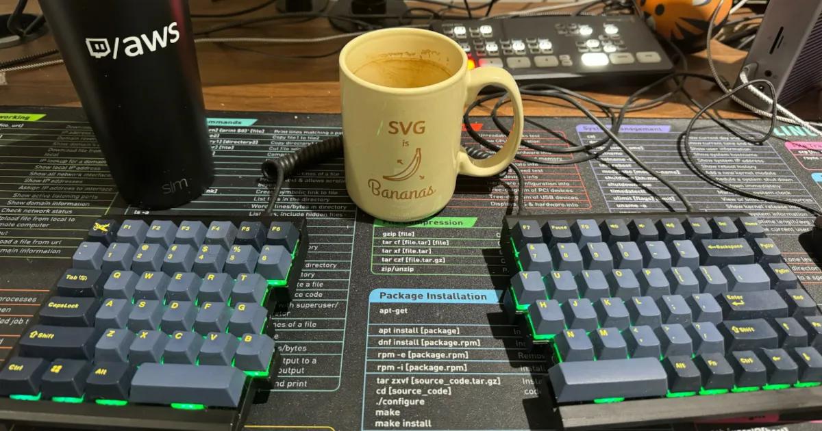Split keyboard with a coffee cup showing a banana with arrows and the text "SVG is bananas".