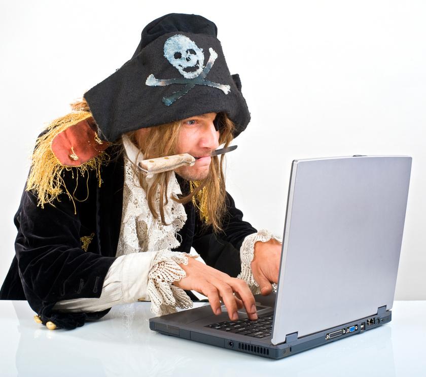 Pirate with a knife in their mouth typing on a laptop