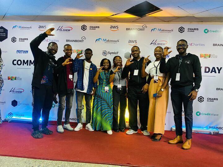 A group photo of the AWS Cloud Club Captains in Nigeria standing on red carpet with a step and repeat logo background.